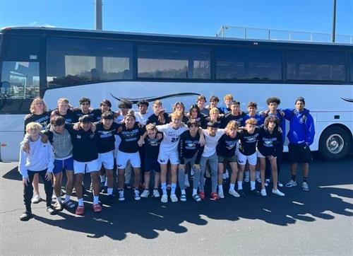 Soccer players in front of bus